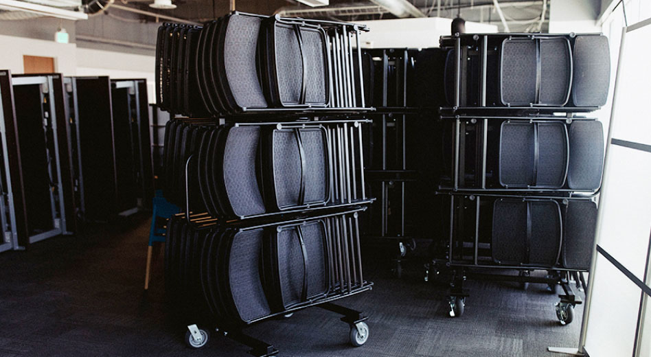MityLite Chairs Folded Up and Stacked On A Folding Chair Cart