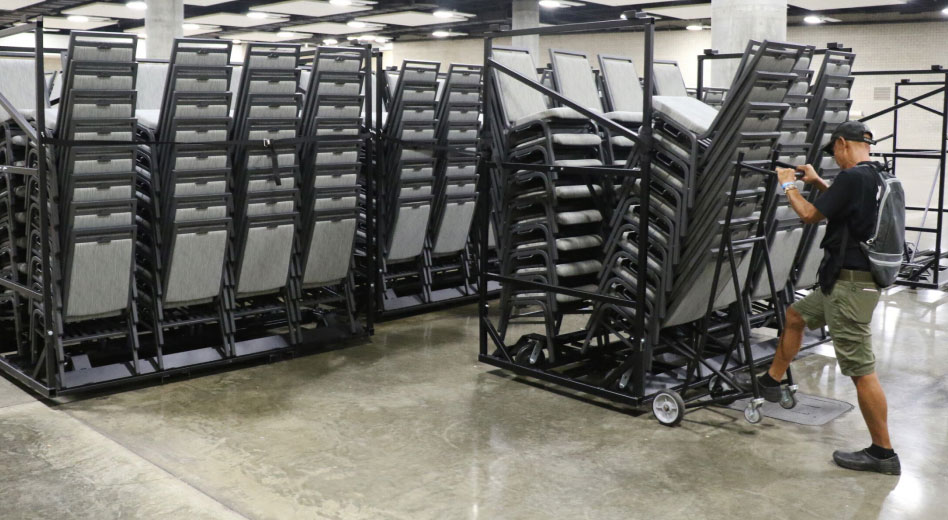 Man Moving A Chair Storage Cart