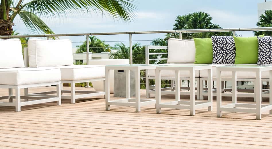 white, modern metal outdoor furniture with matching cushions and vibrant pillows