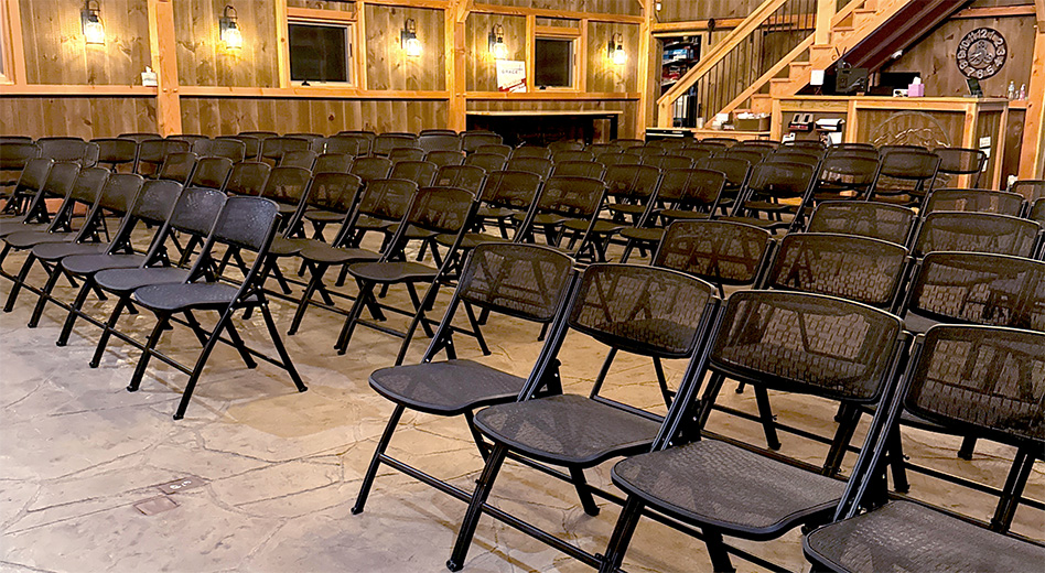 MeshOne folding chairs in a barn-like event space