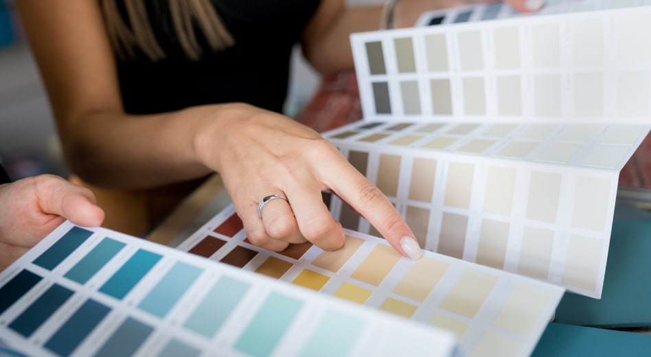 Interior designer choosing from color swatches with client