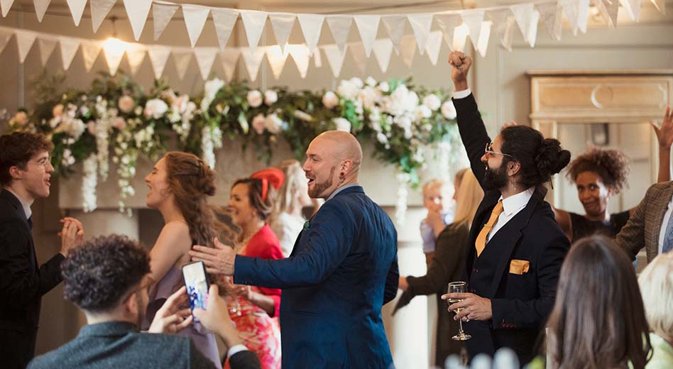 Group dancing and mingling at a wedding