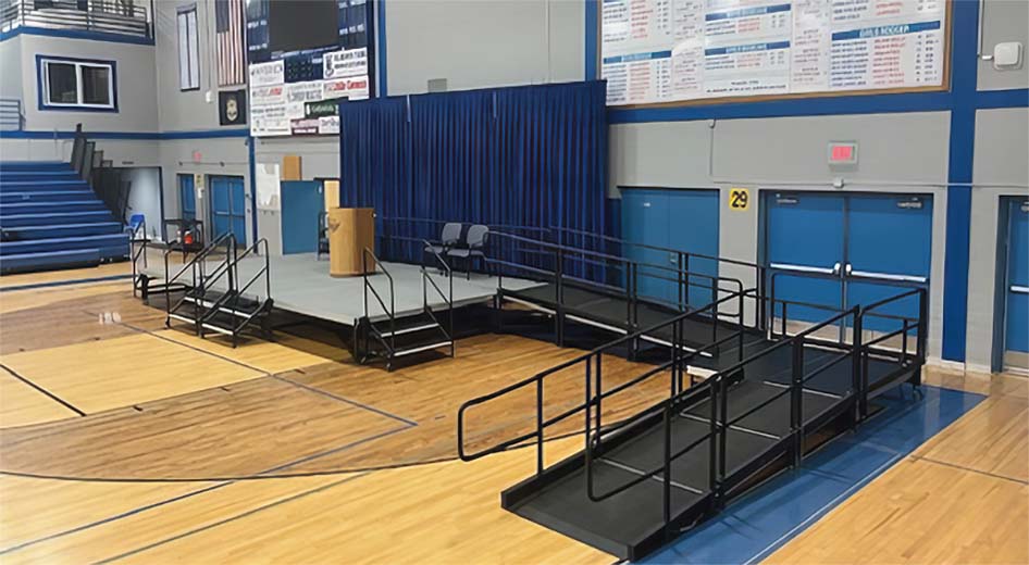 Stage with stairs and ramp in a school gymnasium