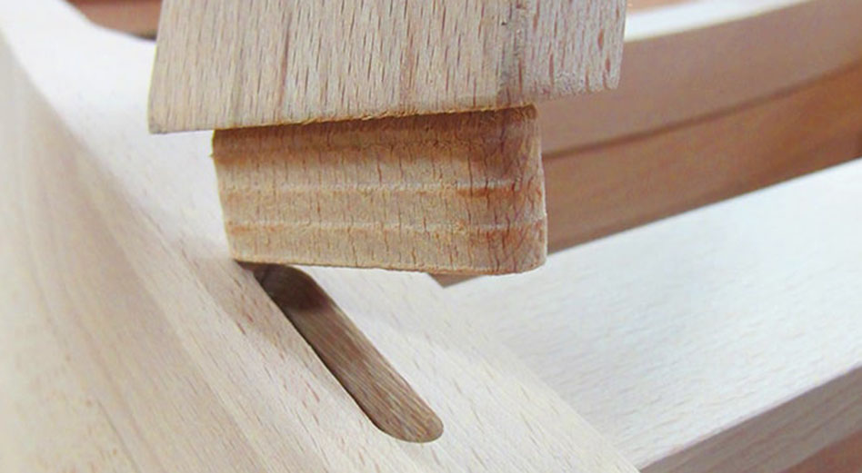 Close up of a wooden chair frame with mortise joints