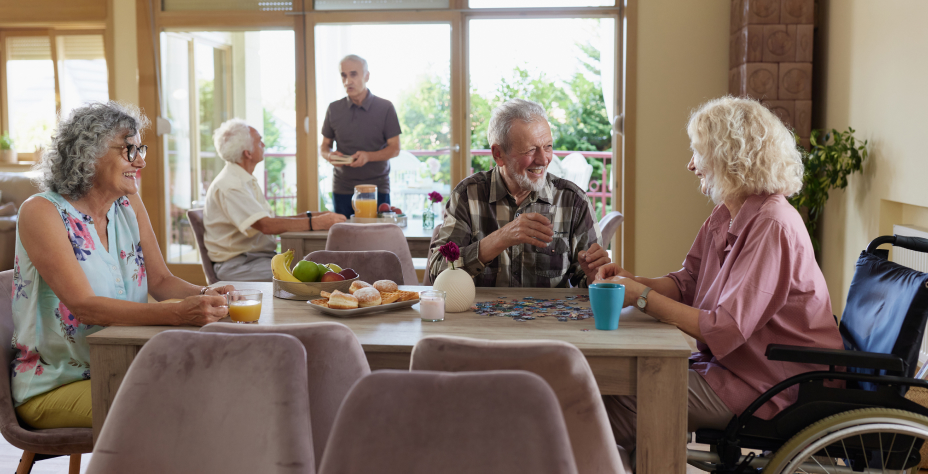 A group of elderly people playing games at a table