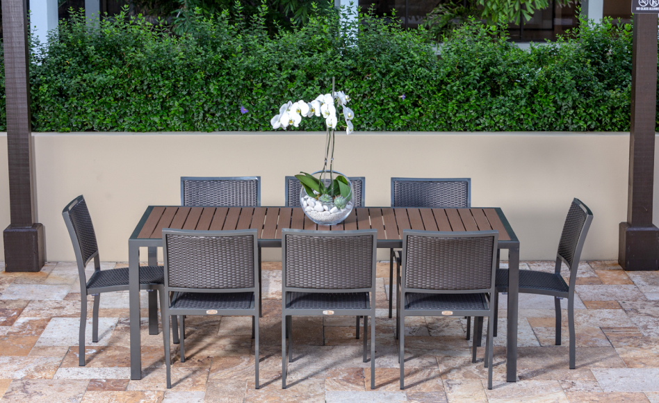 Eight wicker dining chairs at a patio table outdoors