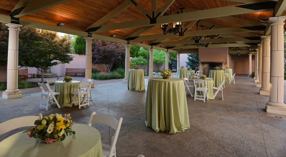 White folding resin chairs at round tables