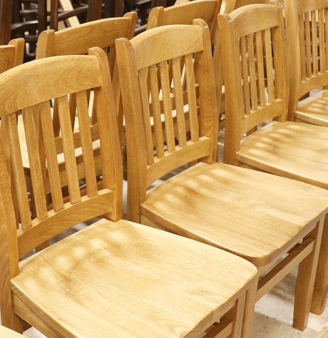 A row of finished wooden chairs