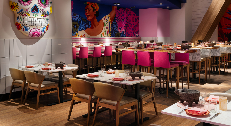 Upholstered wooden chairs in a vibrantly decorated restaurant